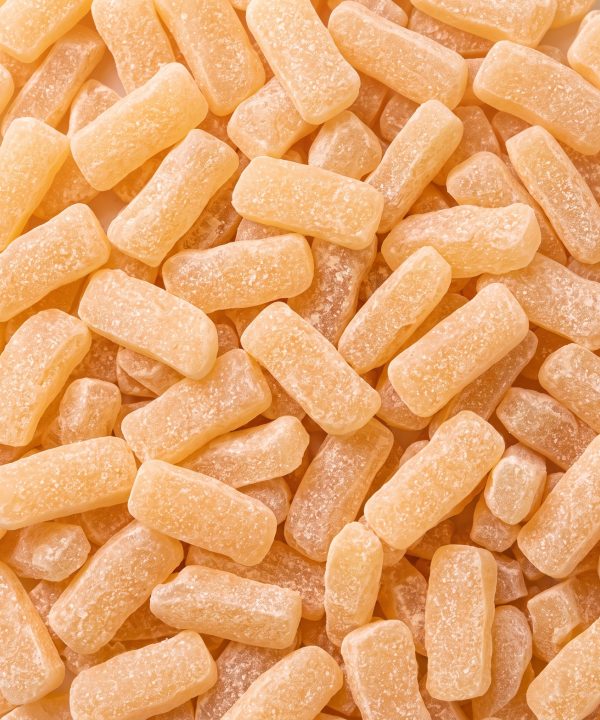 Pale orange herbal tablets scattered together.